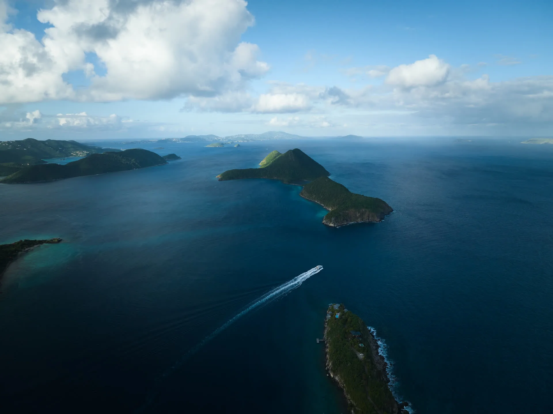 Aerial view of Tortola and Steele Point with a yacht cruising the Caribbean