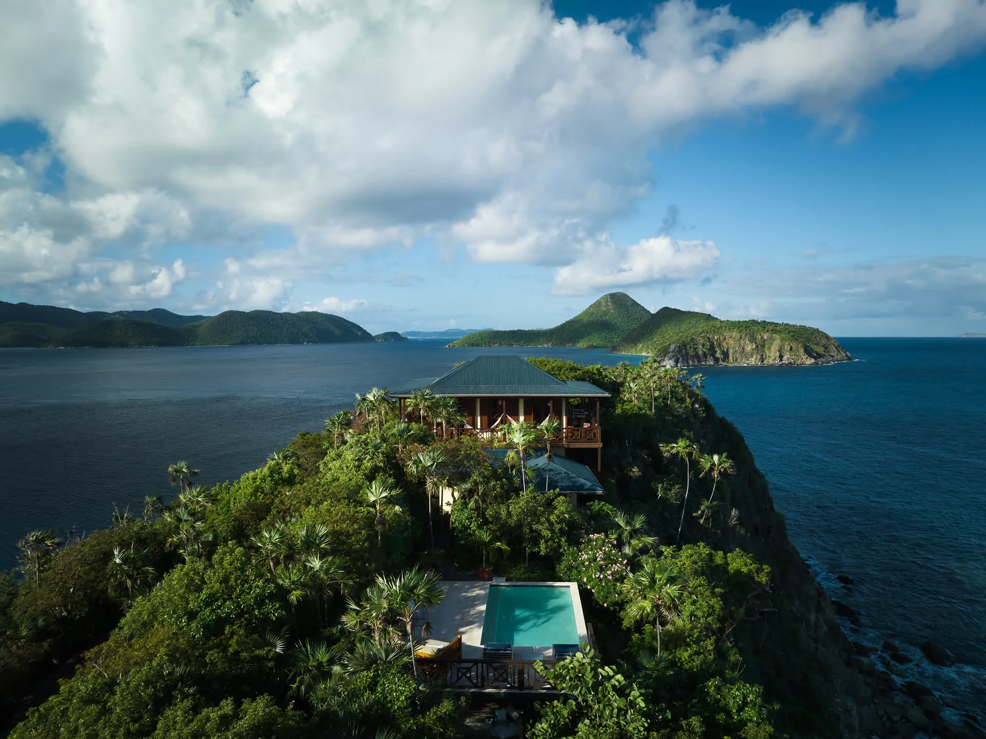 Aerial view of Steele Point’s Treehouse villa on a green clifftop overlooking Tortola’s turquoise bays
